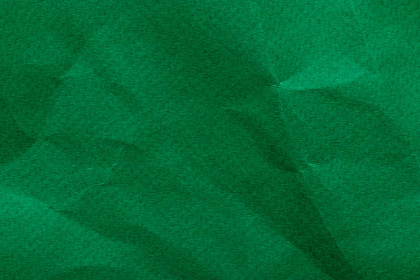 Bright green crumpled thick paper abstract texture, wrinkled background with copy space for design