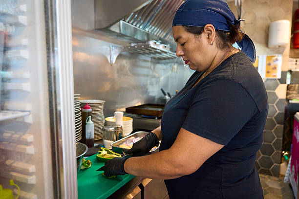 istock Woman chef preparing fresh ingredients in restaurant kitchen 2238579562
