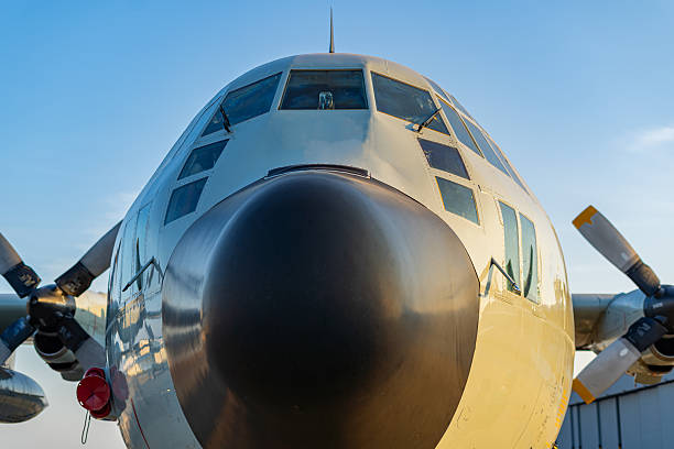 Military transport flying over head, landing at airport