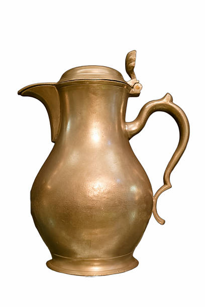 istock Beautiful antique brass pitcher displayed on a clean surface, showcasing its curves and intricate design details 2238581475