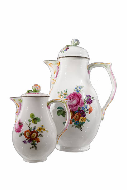 istock Elegant floral porcelain teapot and creamer set displayed in soft light on a rustic table 2238581520