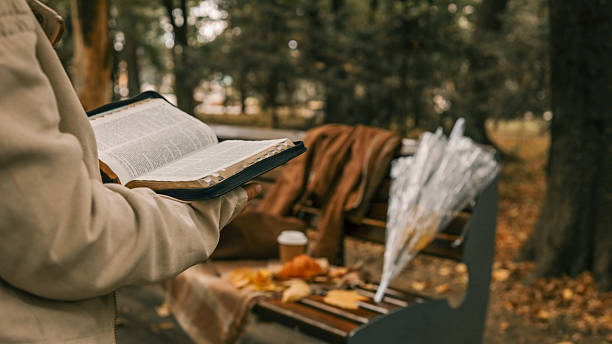istock Reading the Bible in the Park 2238583301
