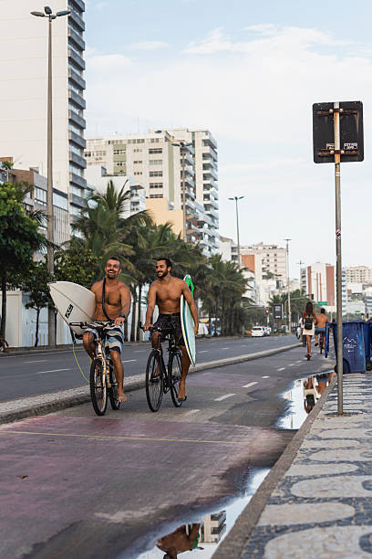 Rio de Janeiro, Brasil – August, 22, 2014: Couple walkin on Ipanema´s sunshine