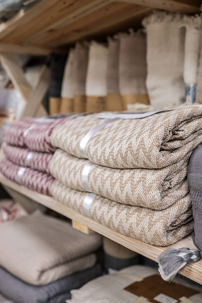 istock Folded blankets on a wooden shelf 2238584395