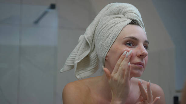 istock Woman, during skin care routine, applying face serum while looking into the mirror 2238584439