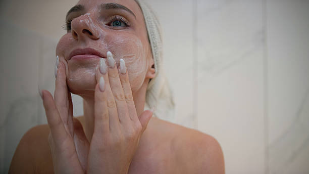istock Woman applying skincare in a bathroom 2238584520
