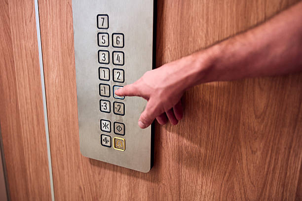istock Person pressing elevator buttons in the building. 2238587970