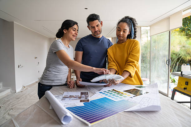 istock Interior designer choosing colors with a couple while remodeling a house 2238588076