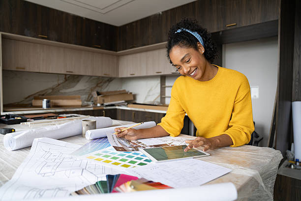 istock Happy interior designer remodeling a house and looking at sketches 2238588100