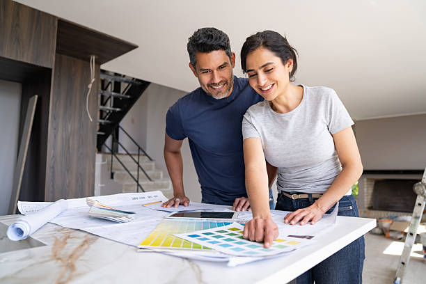 istock Couple having fun remodeling their house and choosing a color 2238588109