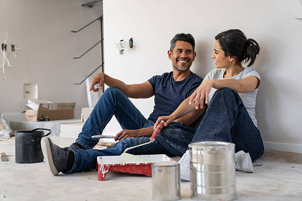istock Happy couple taking a break from painting their house while remodeling 2238588151
