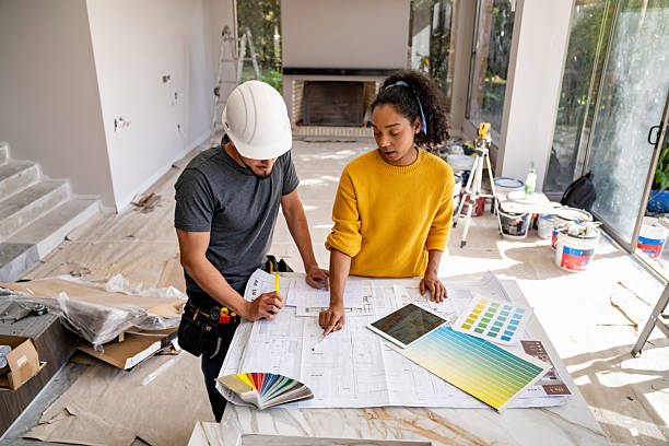 Architect talking to a building contractor while remodeling a house