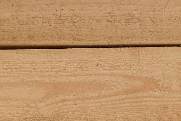 istock Close-up of wooden plank surface with natural grain texture. Rustic timber background for carpentry, woodworking, eco-friendly construction, and design projects. 2238588462