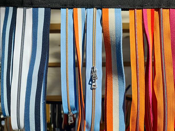 Colorful zippers for haberdashery and sewing, showing stripes and vibrant patterns in an assortment of tapes