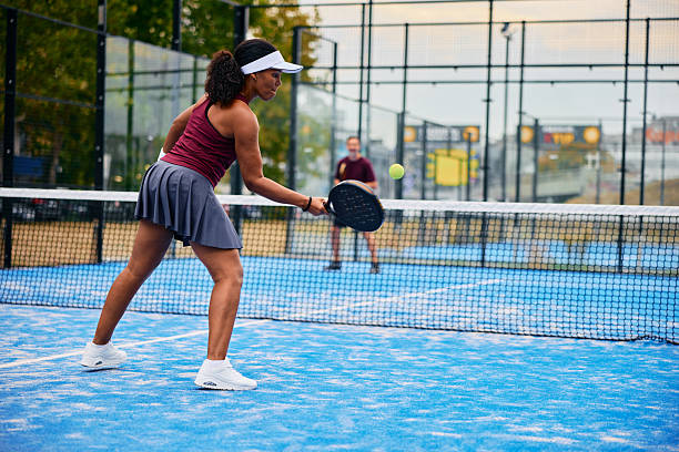 istock Woman playing padel on blue court with racket 2238590212