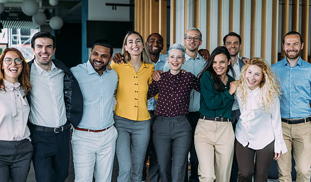 istock Excited coworkers embracing each other during a celebration in the office. 2238591379