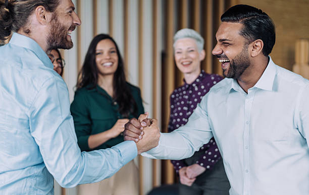 istock Cheerful businessmen clasped hands in the office. 2238591386