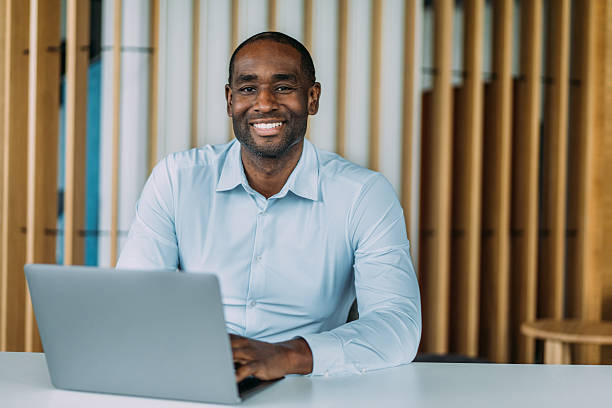 istock Successful businessman in modern office working on laptop. 2238591391