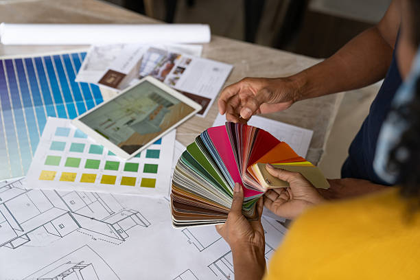 istock Couple looking at a color swatch while remodeling their house 2238592423