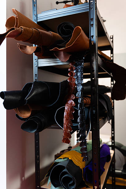 istock Rolled hides in varied tones and grains emphasize diversity, offering craftsmen multiple options for unique and timeless leatherwork. Leather Hide Selection in Workshop. 2238597298