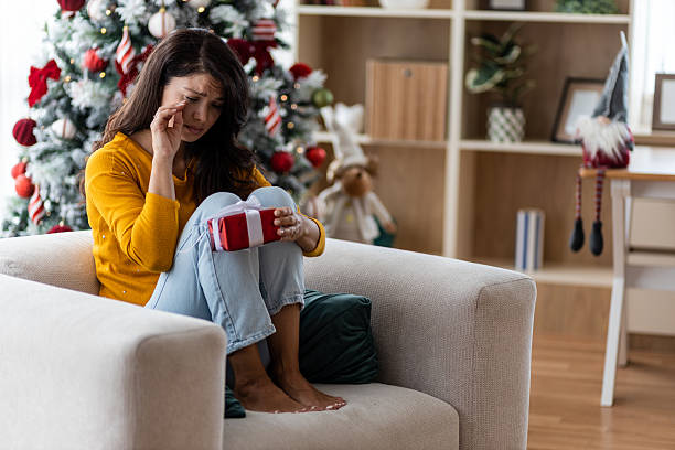 istock Crying woman holding a Christmas present 2238599137