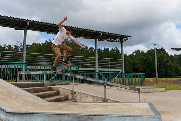 istock Skateboarder grinding on a rail at skatepark 2238599983