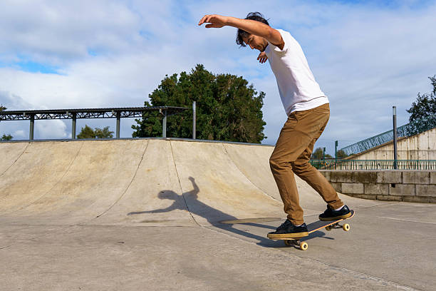istock Young man balancing on skateboard at skatepark 2238600168