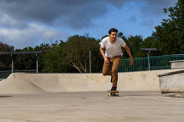 istock Young man skateboarding at a skate park 2238600870