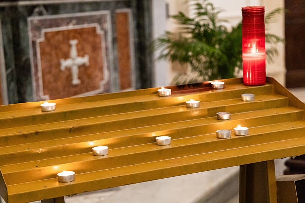istock Candlelit catholic church interior with glowing light 2238601243