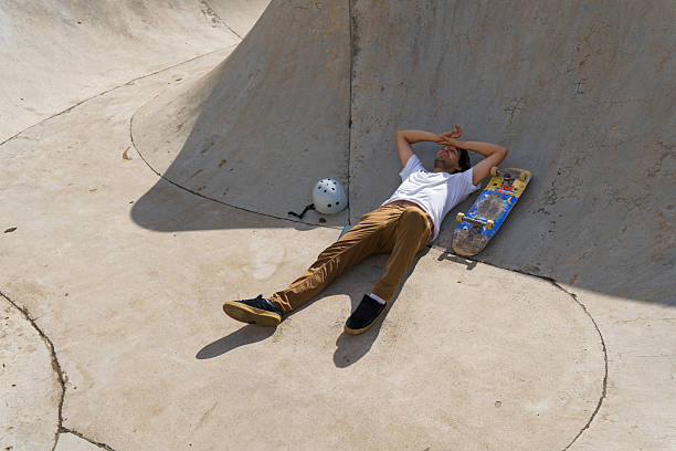 istock Skateboarder man resting tired from hot sunny day 2238601277