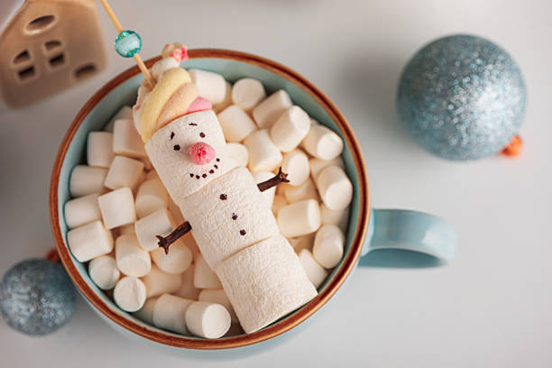 istock Marshmallow Snowman in Mug with Christmas Ornaments and Lights 2238601819