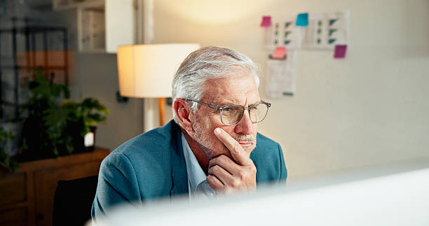 istock Business, thinking and man in workplace, computer and investment with problem solving. Decision, online accounting and mature person in office, PC and research for stock market, choice and doubt 2238605804