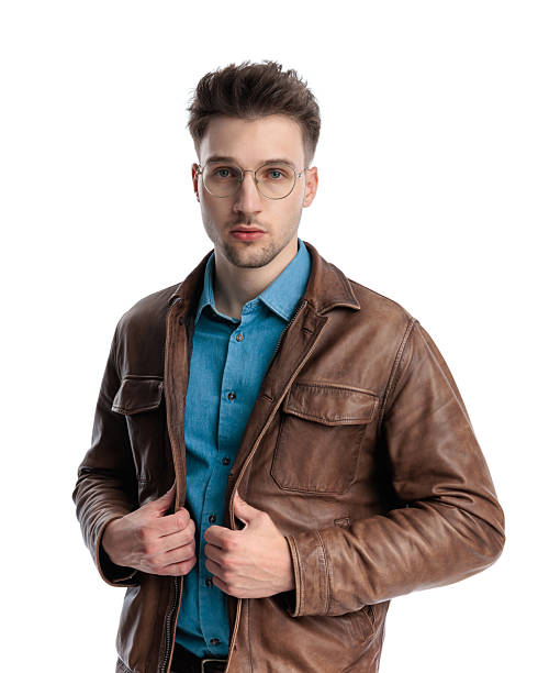istock attractive blonde man with glasses fixing brown leather jacket 2238611913