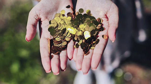 istock Female hands spreading golden confetti, representing triumph, celebration, and festive excitement 2238613045