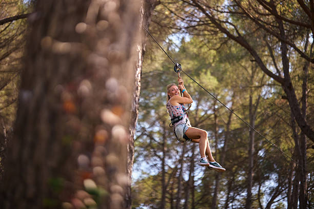 Woman enjoying adventure ziplining through a forest
