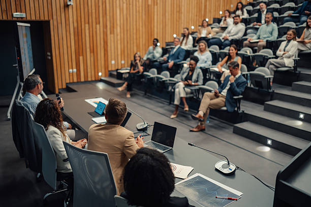 istock Business professionals attending a conference and seminar presentation 2238623610