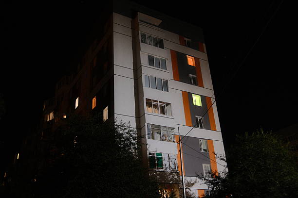 istock Tall apartment building shows illuminated windows at night 2238623712