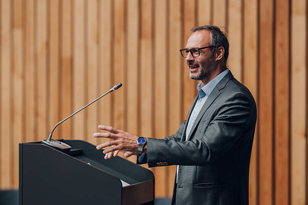 istock Businessman giving public speech at corporate conference 2238623723