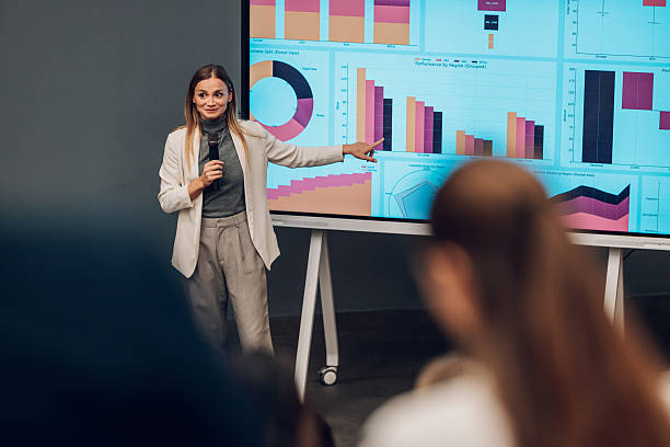 istock Woman speaker giving business presentation with data charts 2238625551