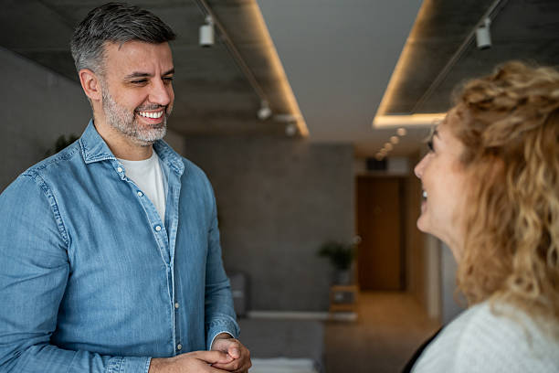 istock Mature man talking with a woman, smiling conversation 2238625833