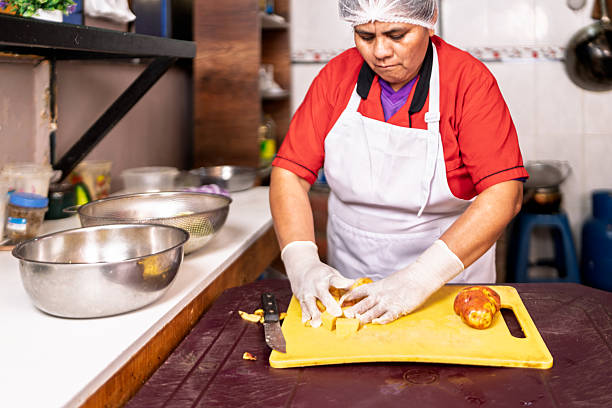 istock Woman chef preparing potatoes in a small restaurant kitchen 2238627259