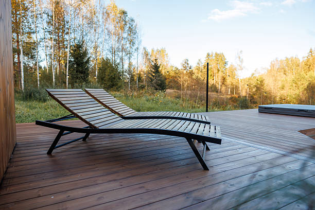 istock Wooden Deck with Lounge Chairs and Hot Tub Surrounded by Trees 2238630697