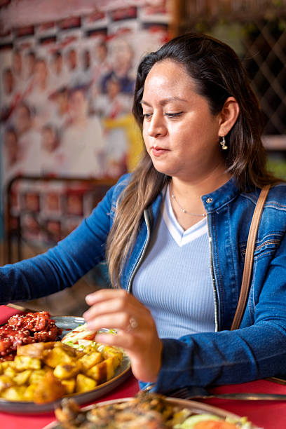 Woman enjoying fried fried food in casual restaurant setting