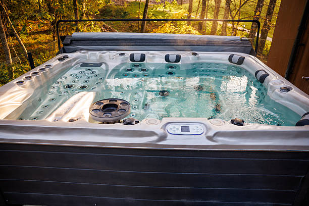 istock Outdoor Hot Tub on Raised Deck Surrounded by Autumn Trees 2238634599