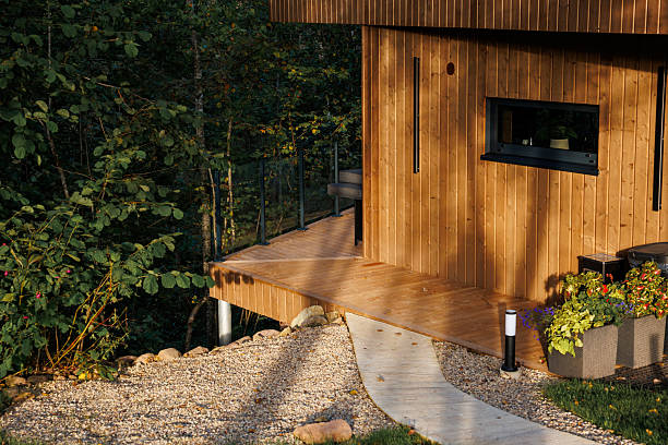 istock Modern Wooden Structure with Deck, Glass Railing, and Gravel Pathway 2238634659