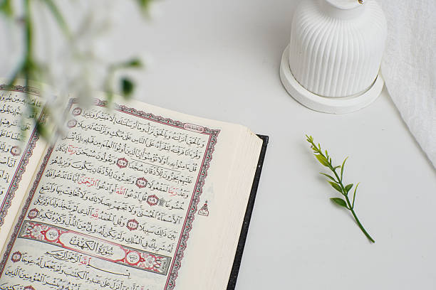 istock Open Quran with Green Leaf and White Vase on Minimalist Background 2238637829