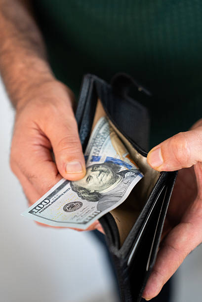 istock Taking out money from wallet 2238638187