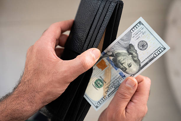 istock Close-up hand holding dollar bill 2238638263