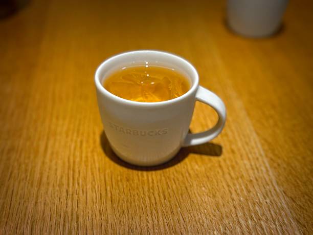 Starbucks Mug with Tea on Wooden Table