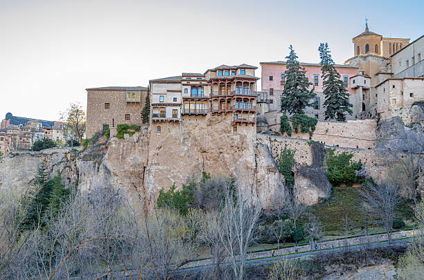 Cuenca, Spain - March 28, 2015: The Hanging Houses (Spanish: Casas Colgadas) in Cuenca, Spain. They are so named because part of them has a corbelled roof, or large balconies, jutting out from the high rocky ledge of the Huecar River gorge. The only three examples of this type of building that still survive are the House of the Mermaid and the two Houses of the Kings, built between the 13th and 15th centuries. They house the Museum of Spanish Abstract Art